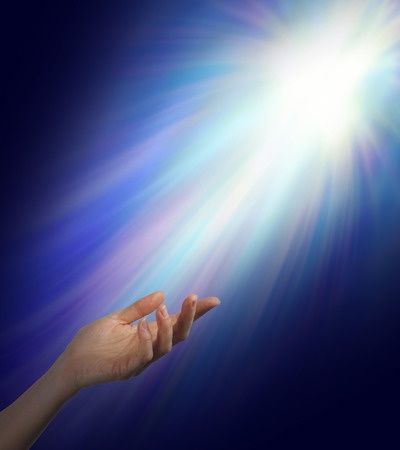 47600745 - seeking spiritual guidance female hand reaching upwards into a bright energy burst with subtle rainbow color strands with plenty of copy space